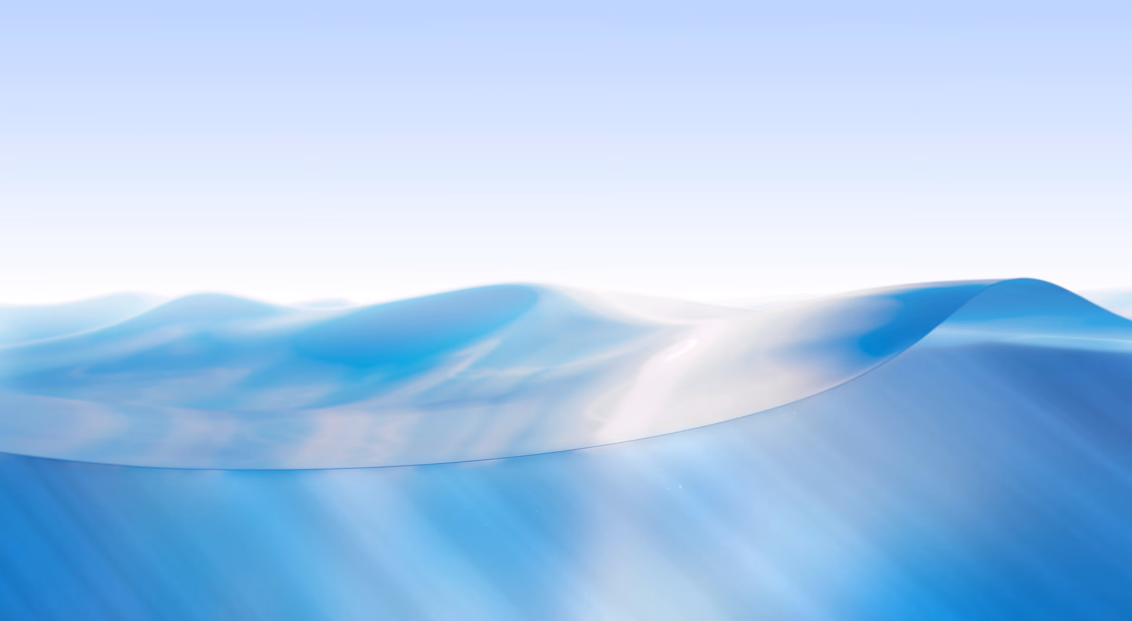Soft blue sand dunes under a clear sky with sunlight casting gentle shadows.